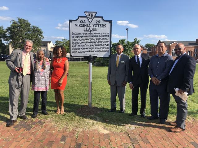People standing with the Virginia Voters League Historical Marker